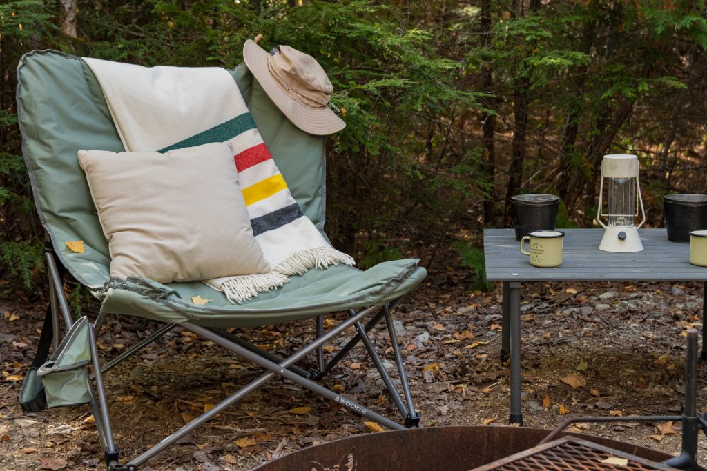 Canada Woods Mammoth camping chair with a Pendleton blanket and pillow in the woods of Maine.