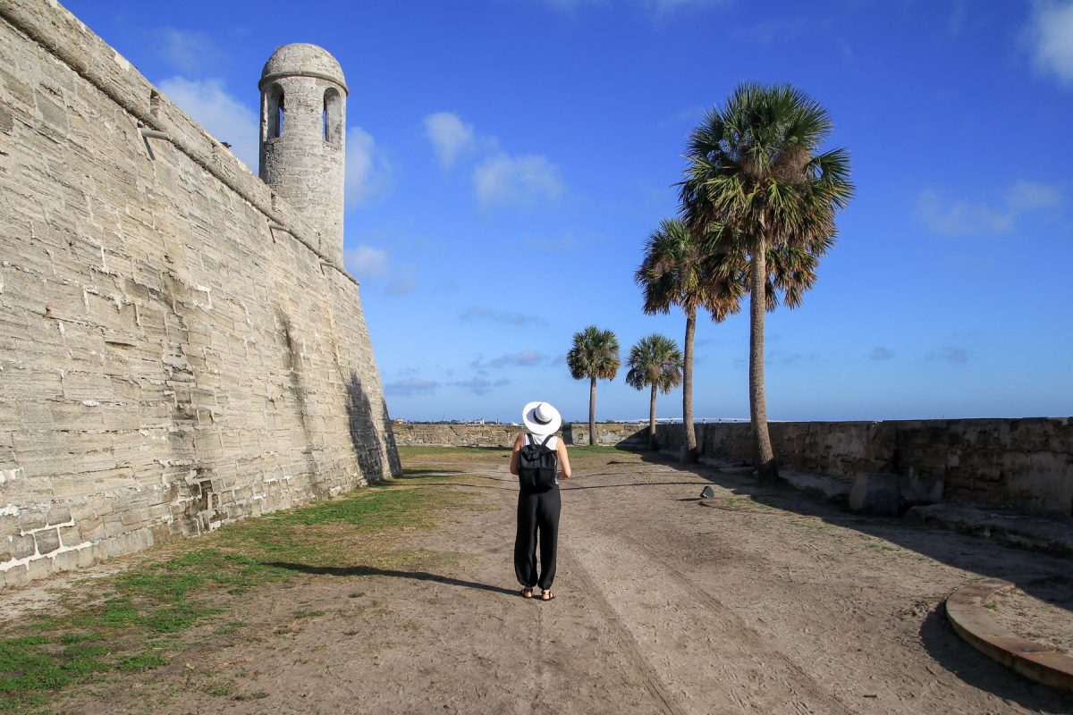 A woman walks along the Castillo de San Marcos National Monument in St. Augustine, Florida. 