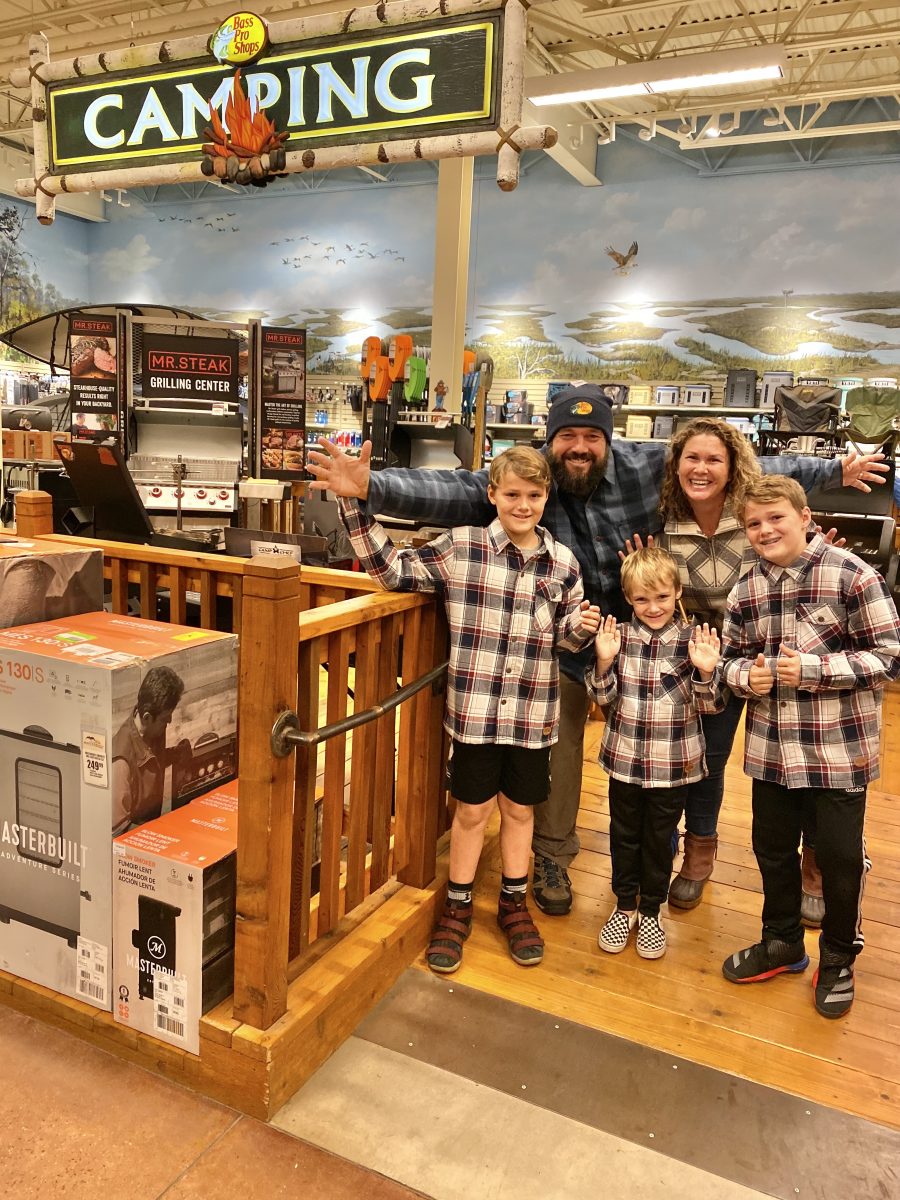 Family in plaid together at Bass Pro Shop.
