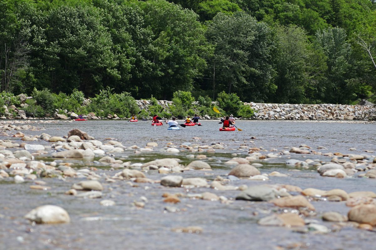 A group of kayakers go down the Glen River at the Yogi Bear's Jellystone Camp Resort: Glen Ellis campground in Glen, New Hampshire.