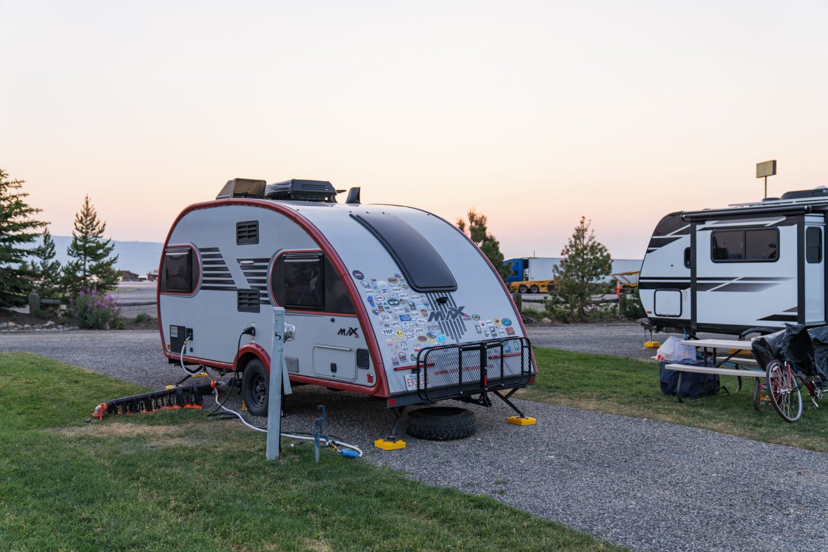 A teardrop travel trailer sitting at a campsite with full hookups at Valley View RV Park and Campground in Island Park, Idaho, just outside of Yellowstone National Park.