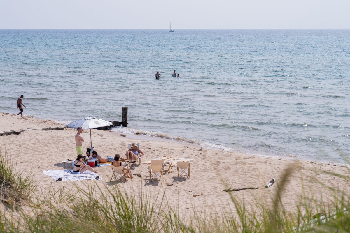 A group of friends relax at Ludington State Park Beach on Lake Michigan.