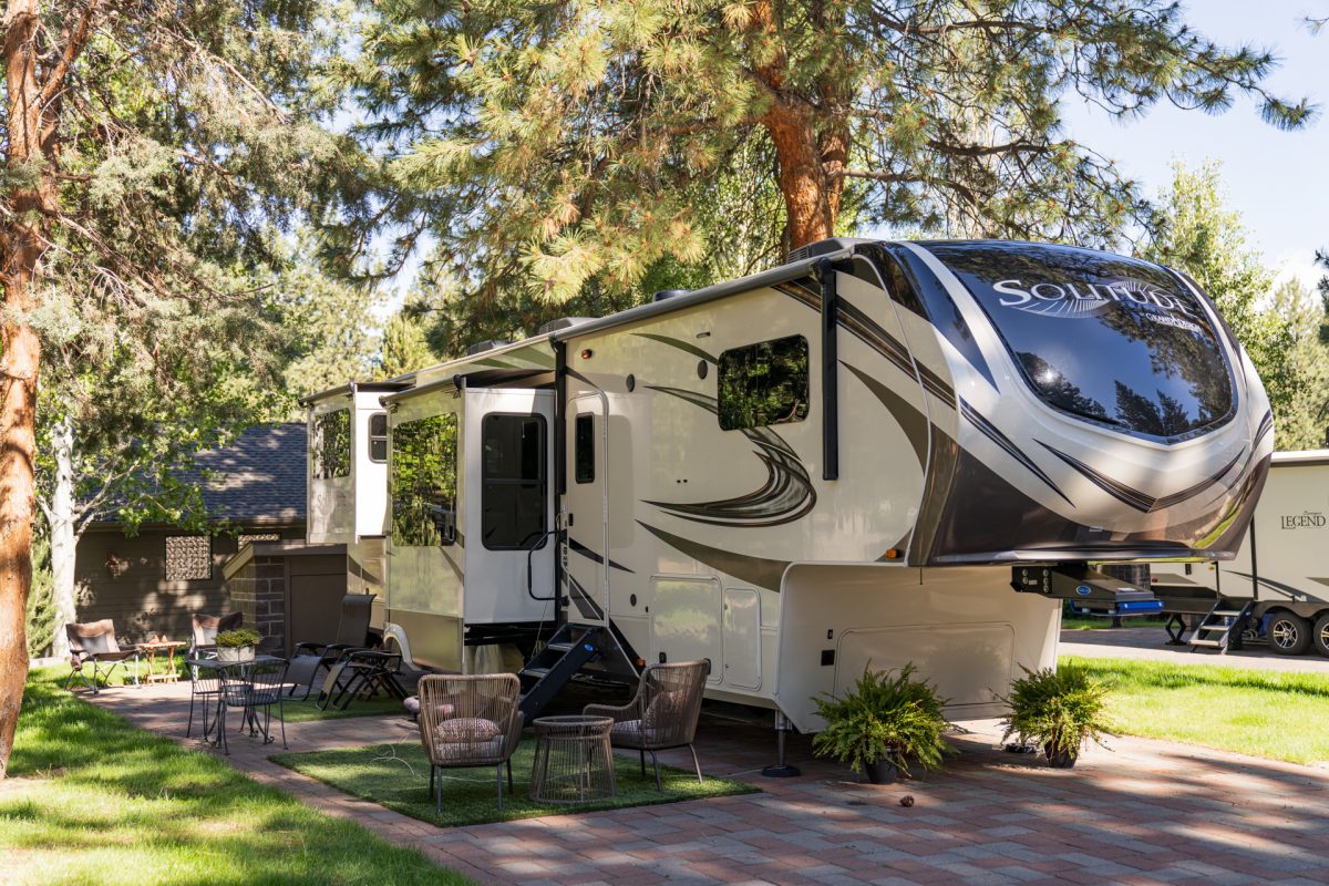 A fifth-wheel travel trailer and RV sits at its campsite at the Crown Villa RV Resort in Bend, Oregon.