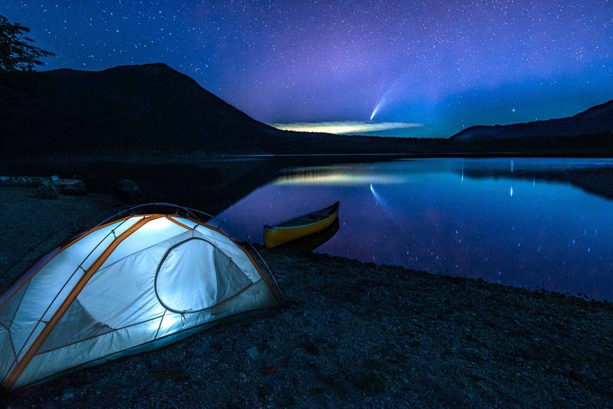 A tent on a beach at night. 