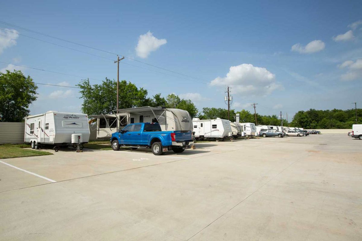 A blue truck and row of campers parked at Danny's RV Resort, a campground near Houston, Texas. 