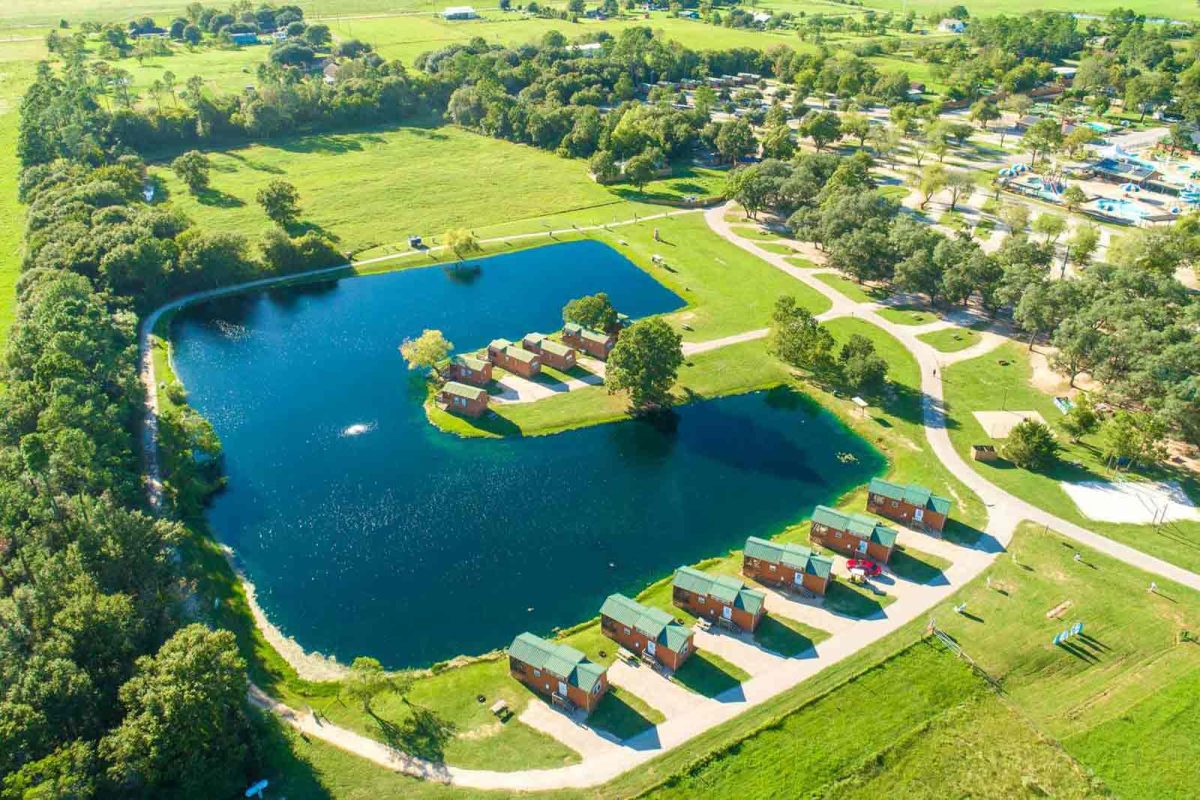 An aerial shot of the pond and campsites at Yogi Bear's Jellystone Park Camp-Resort: Waller, one of the  campgrounds near Houston. 