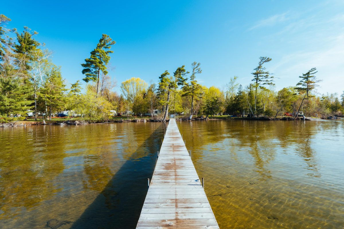 The view of a dock over the water at Leelanau Pines Campground, a campgrounds near hiking trails. 