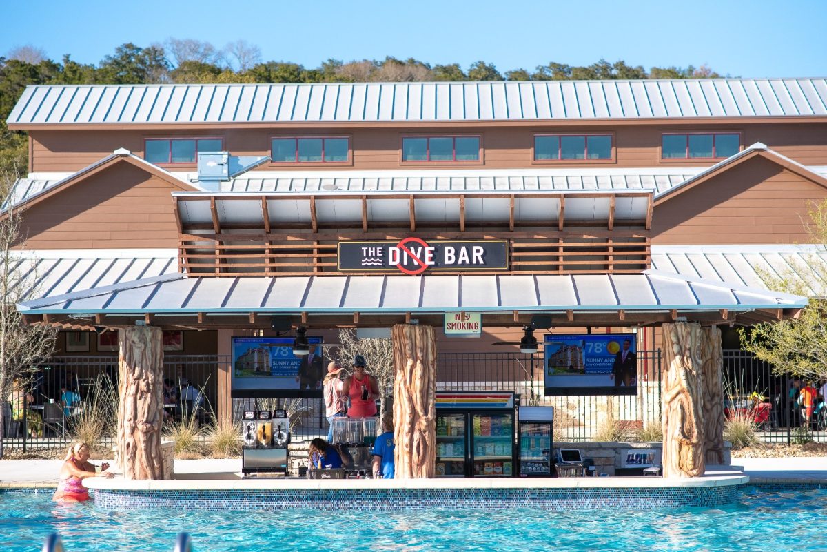 A poolside bar with the sign No Dive Bar overhead at Camp Fimfo. 