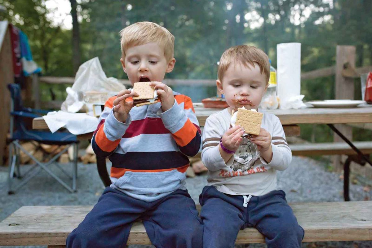two young boys eating s'mores