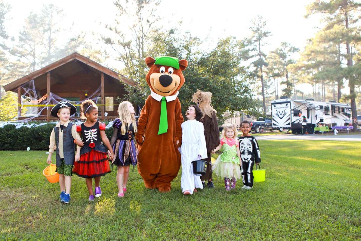 kids in Halloween costumes with Smokey Bear mascot at Halloween camping site