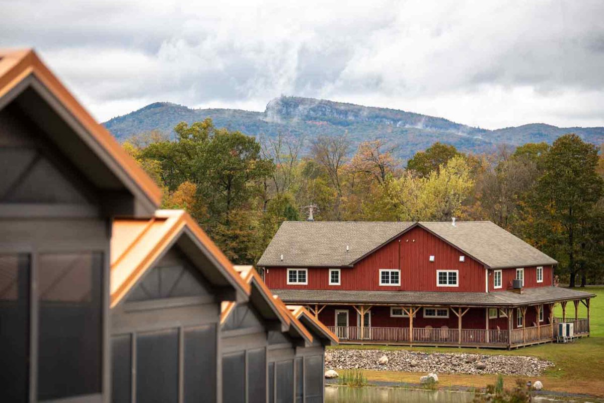 Cabins with mountains in the background at Yogi Bear's Jellystone Park™ Camp-Resort: Gardiner