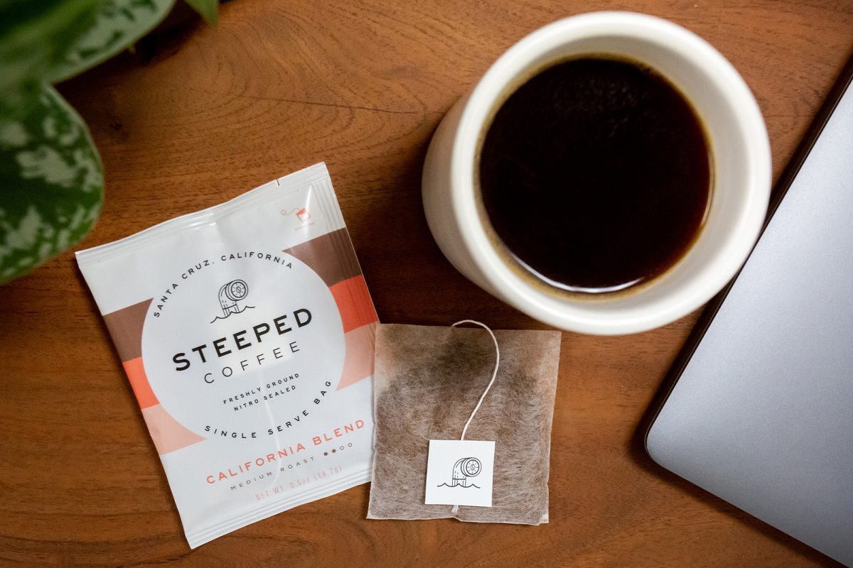 A cup of coffee and a bag of steeped coffee - one of our camping gift ideas for the holidays. 