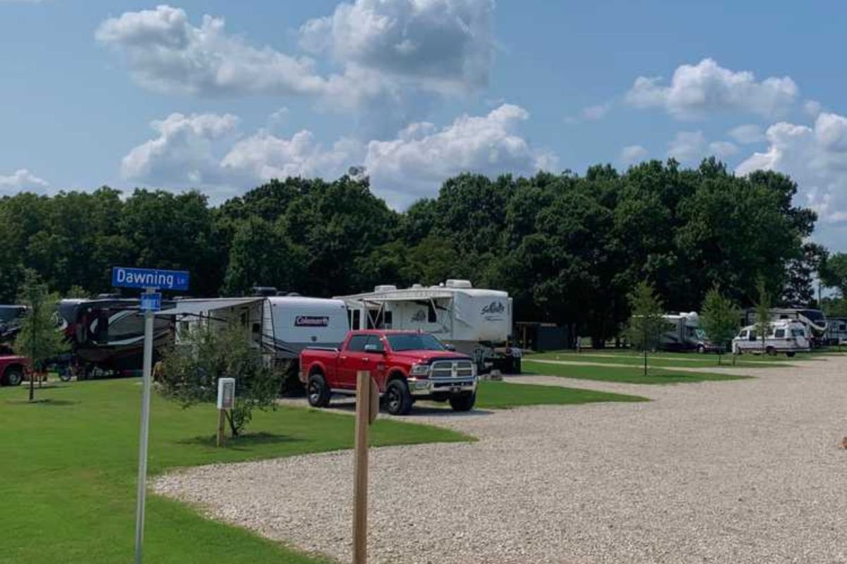 red truck and RV parked by green spot at Dallas campground