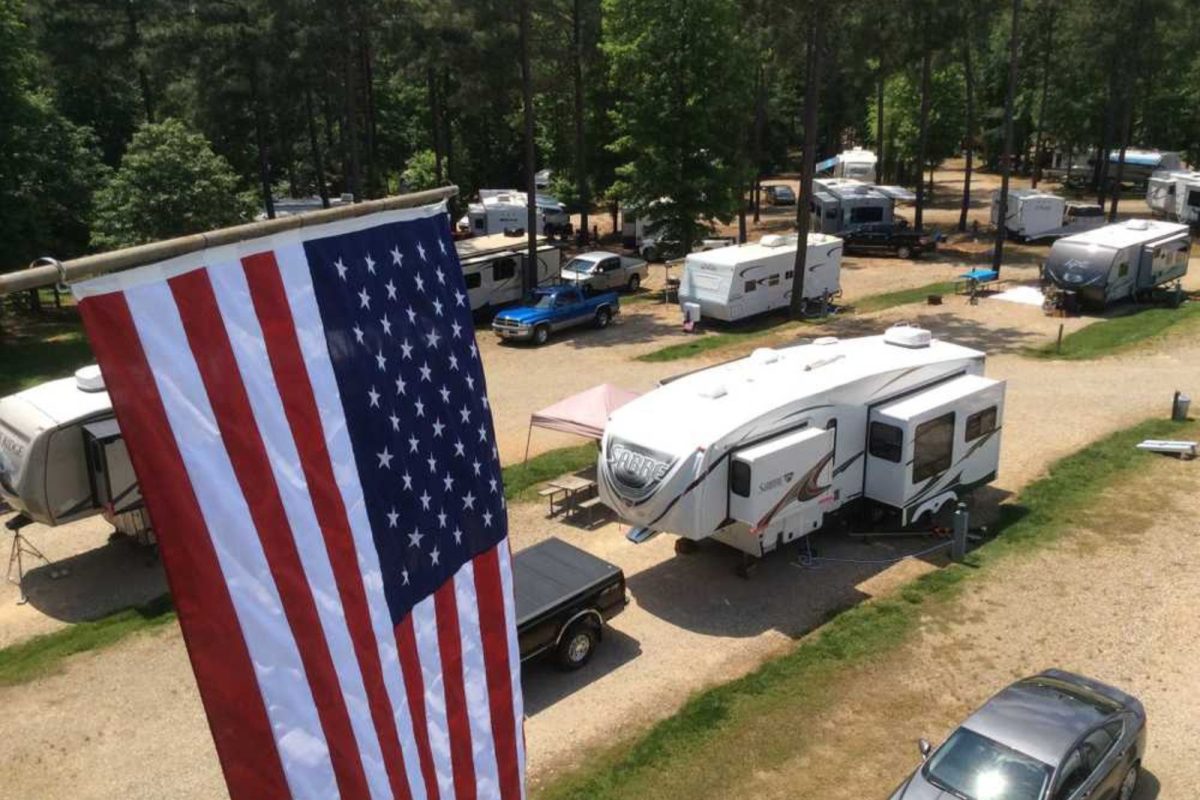American flag hanging over parked RVs at campground