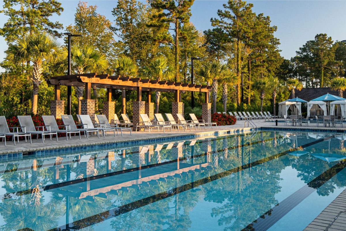 beautiful pool with lounge chairs and cabanas at Carolina Pines campground
