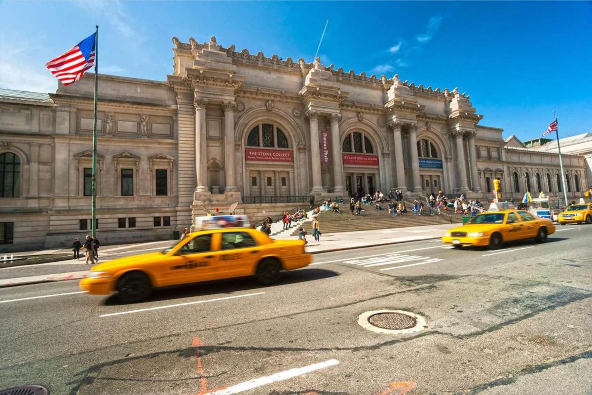 cabs driving by the Met in NYC
