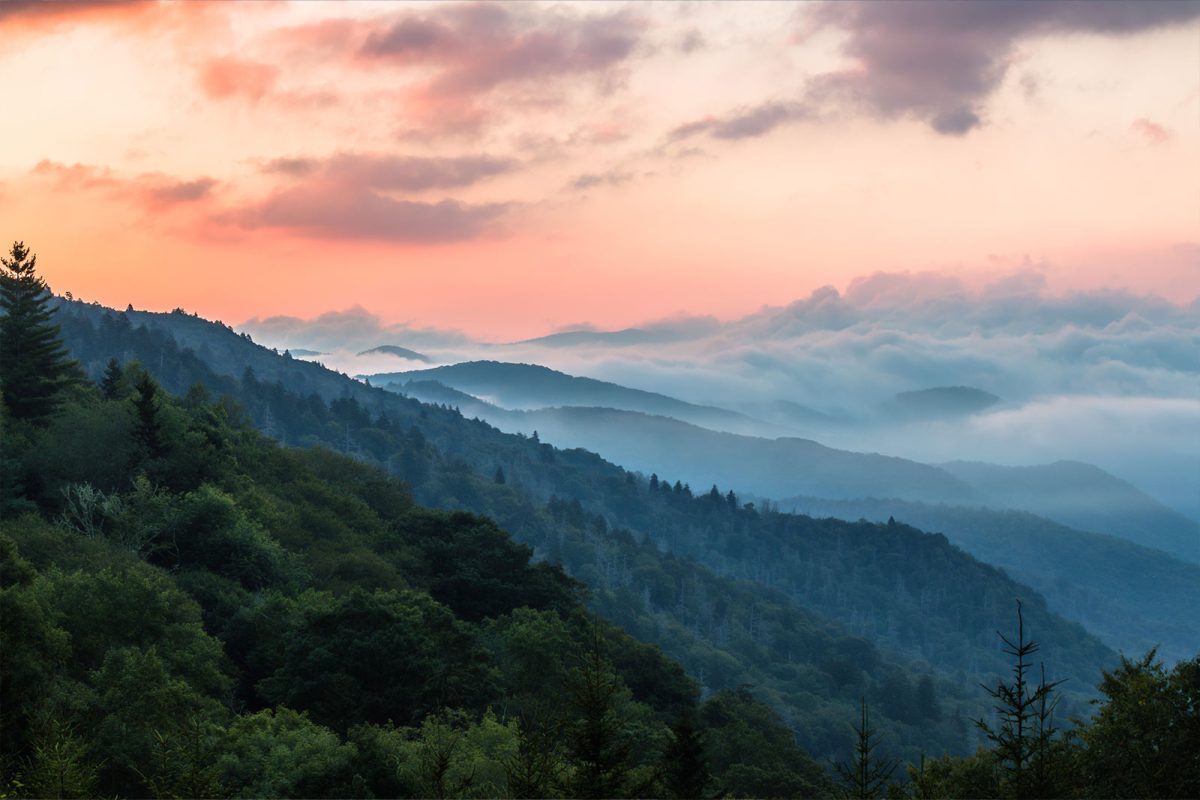 Clouds hang over blue mountain ranges in Great Smoky Mountains National Park. 