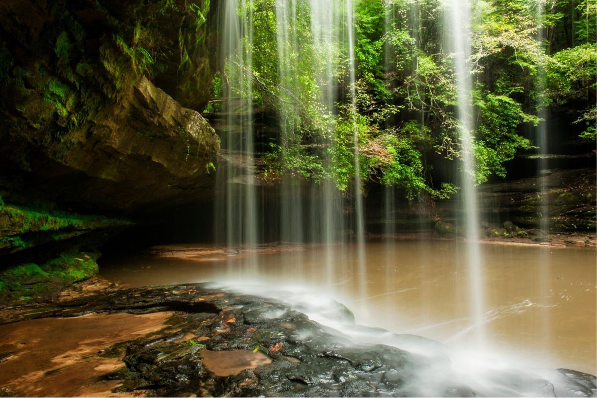behind a waterfall in Bankhead National Forest in Alabama, a top spring break camping destination
