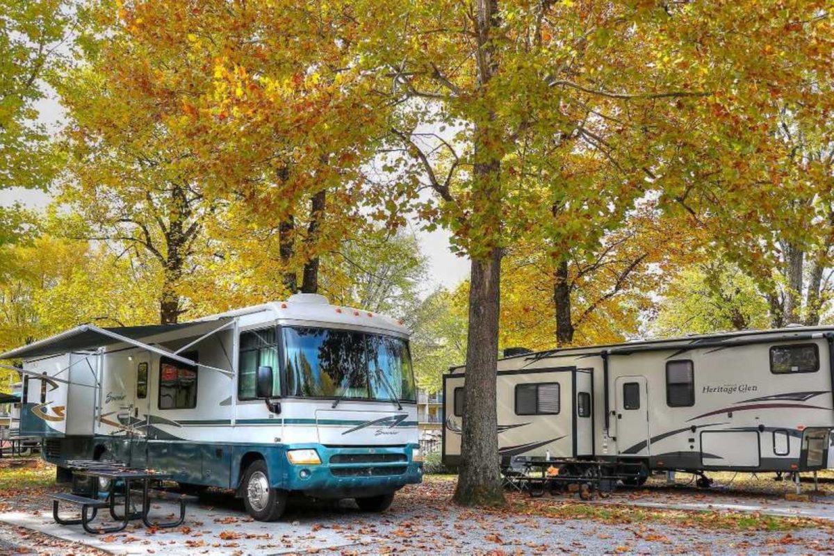 two RVs parked under trees at Camp Riverslanding near Pigeon Forge