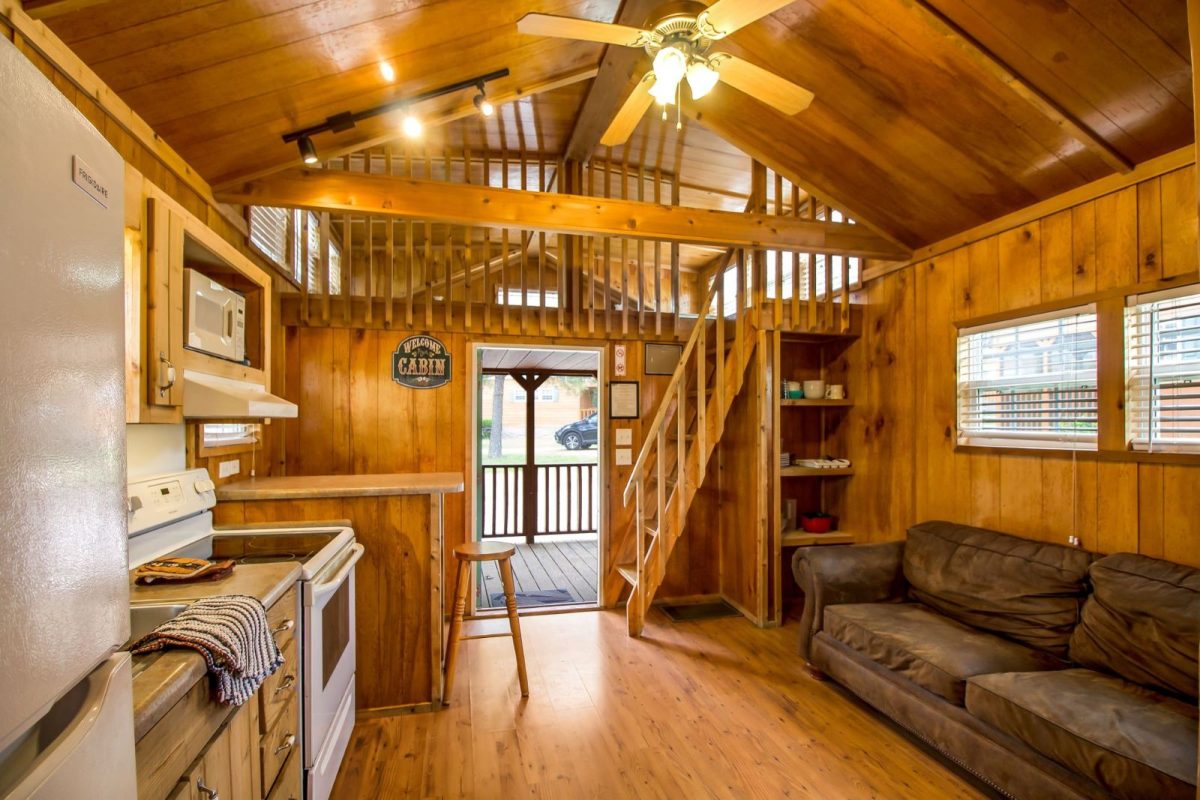 inside two-story cabin with couch at campground