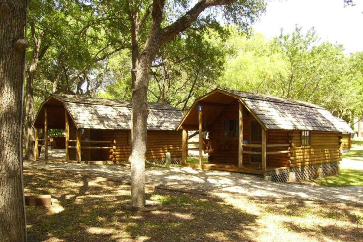 two cabins under trees at Austin Lone Star campground